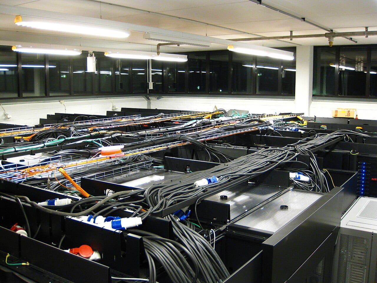 Rows of computer servers with blue lights in a data centre