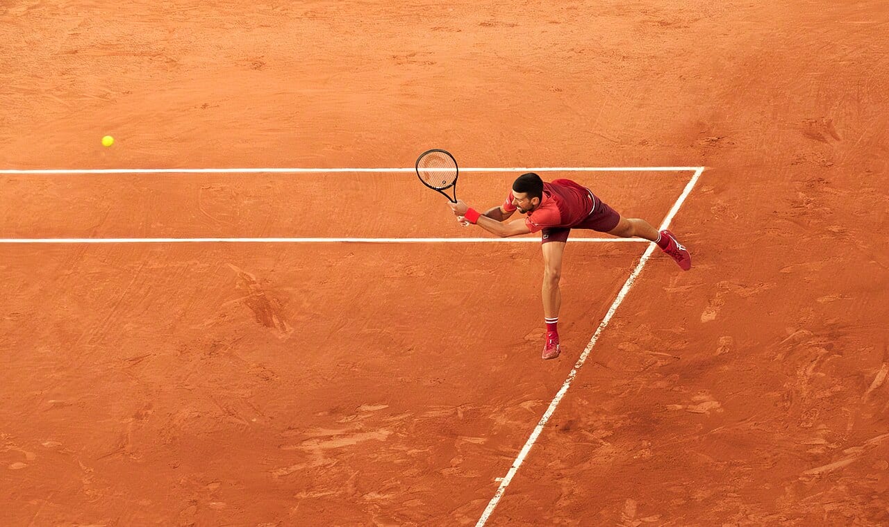 Tennis player Novak Djokovic holding a racket on court