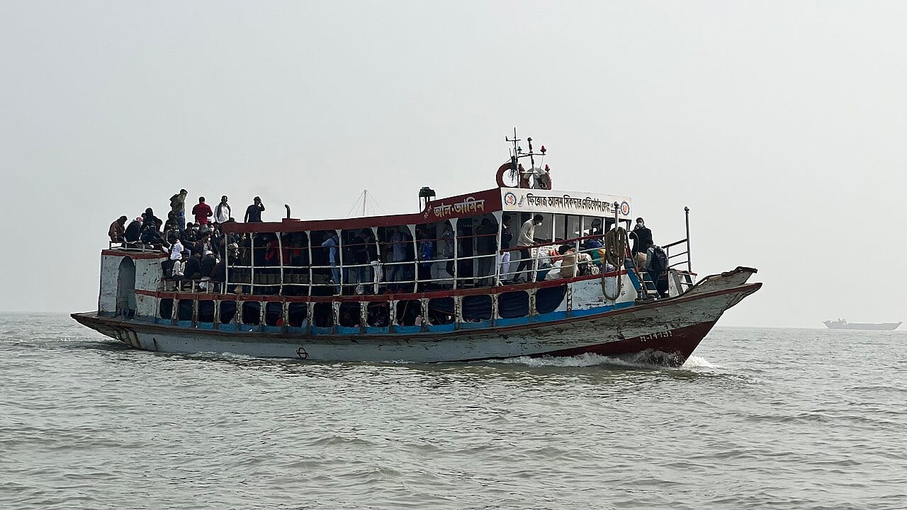 A white passenger ferry sailing on choppy blue sea
