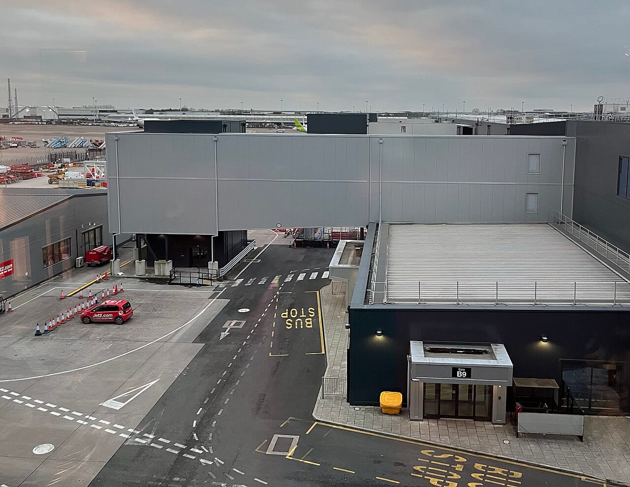 Passengers walking inside a busy Manchester Airport terminal building