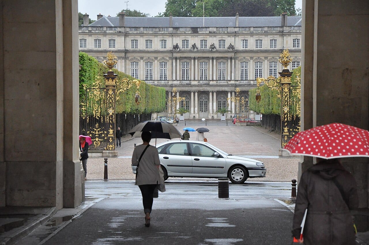A colourful umbrella held up in heavy rain