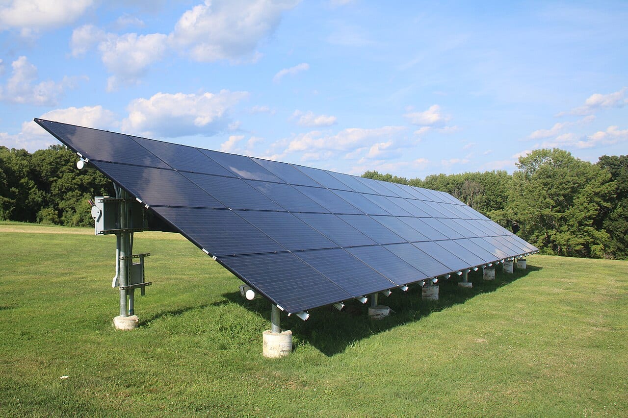 A solar panel standing on a sunny garden balcony
