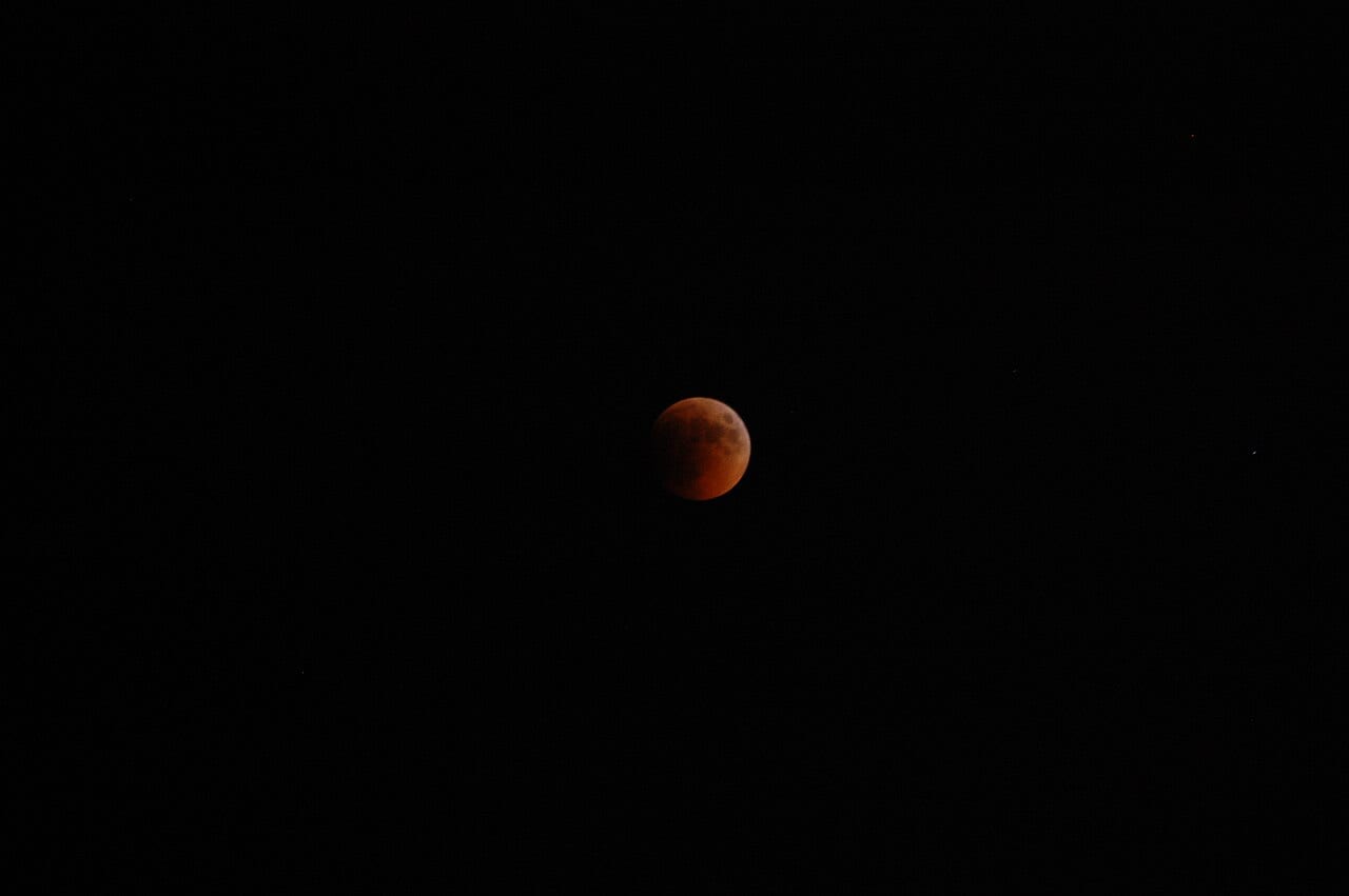 A full moon glowing red during a lunar eclipse